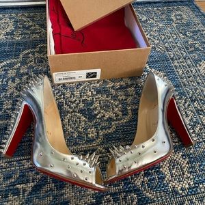 Silver spiked Christian Louboutins red bottoms